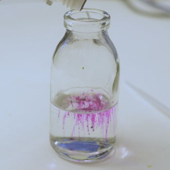 Adding small amounts of Rhodamine B until faintly pink